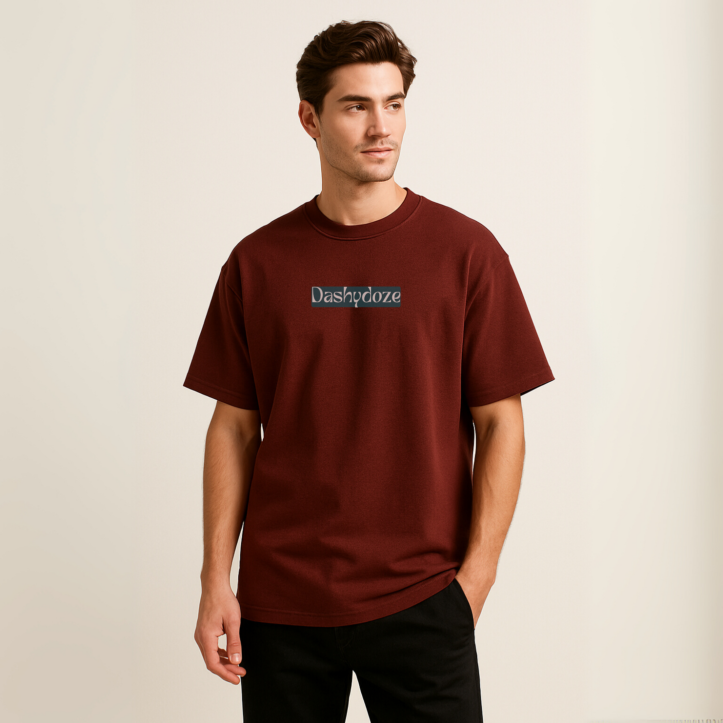 Man wearing a maroon t-shirt with 'Dashdoze' logo on a beige background