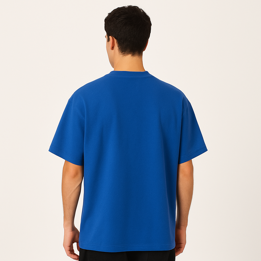 Person wearing a blue t-shirt on a plain background